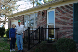 Brenda and Moyler Pond standing in front of their house